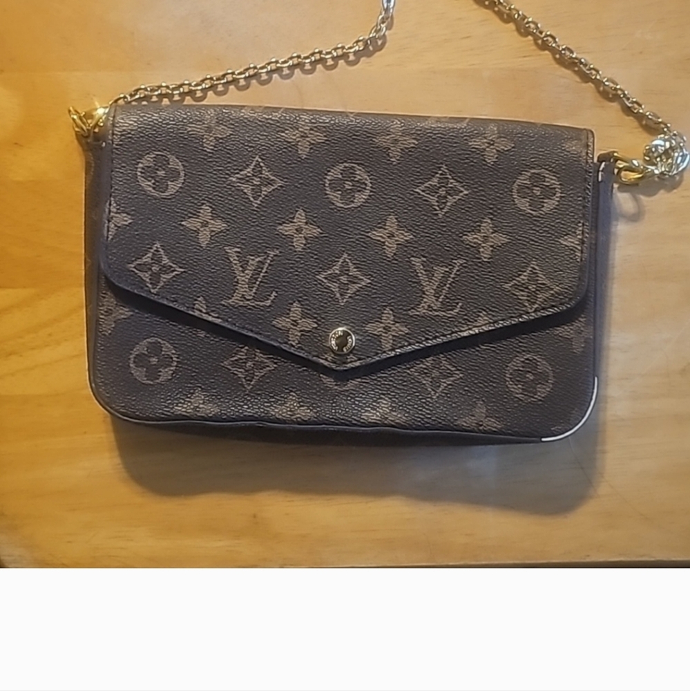 Louis Vuitton clutch purse.